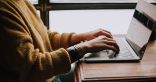 women writing something on her laptop