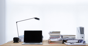 Laptop and documents on desk