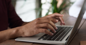 hands writing on the computer