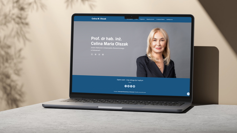 grafika ozdobna: zrzut ekranu strony JMR prof. Olszak, który wyświetla się na laptopie