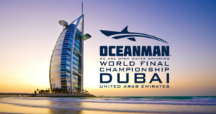 Swimmer in Dubai with the Burj Al Arab and “OCEANMAN World Final” logo in the background.