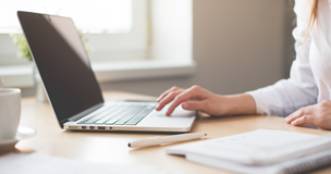 someone write something on laptop