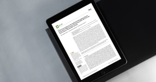 Open academic article placed on a dark desk surface, representing a PhD student’s scientific publication.