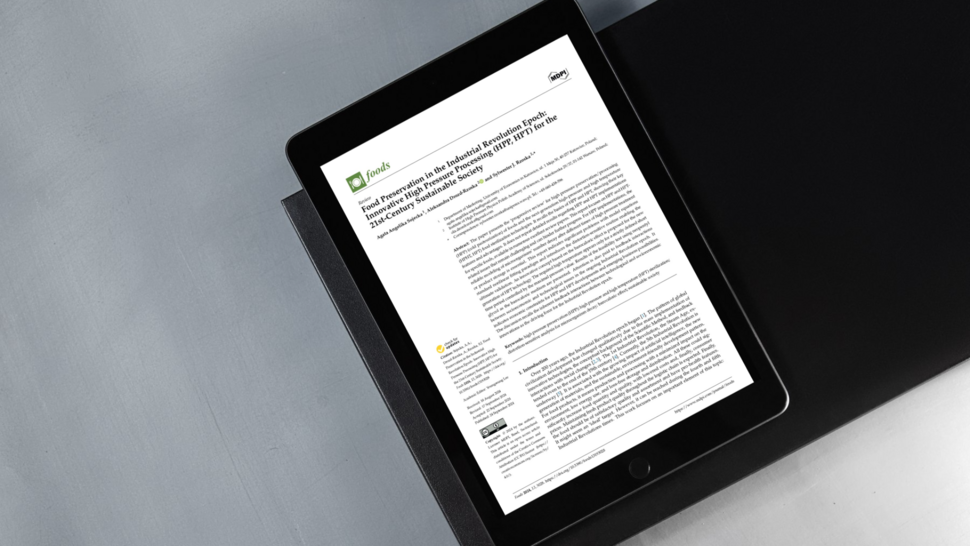 Open academic article placed on a dark desk surface, representing a PhD student’s scientific publication.