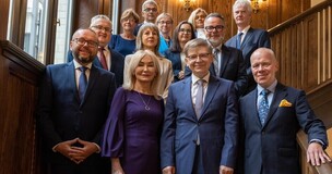 Group of formally dressed university leaders posing for a photo after appointments to management roles.