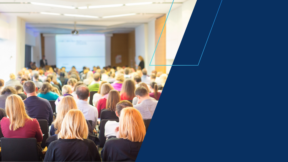 Audience seated in a lecture hall watching a speaker during International Women’s Day open lectures.