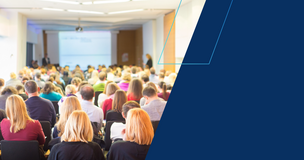 Audience seated in a lecture hall watching a speaker during International Women’s Day open lectures.