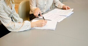 sylwetki kobiet podpisujących dokument