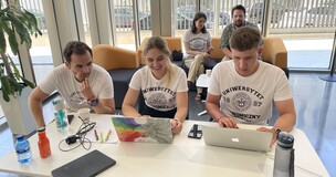 On the picture we can see three students and two teachers.