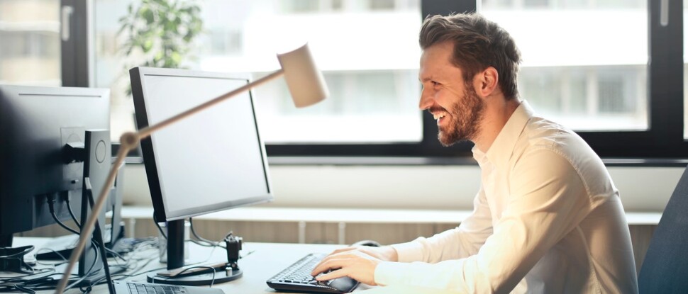mężczyzna siedzący przez komputerem